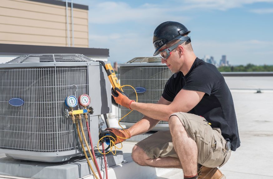 professional HVAC installation - man installing an HVAC unit