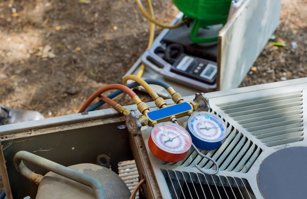 Tools used for heater repair sitting on top of an HVAC unit