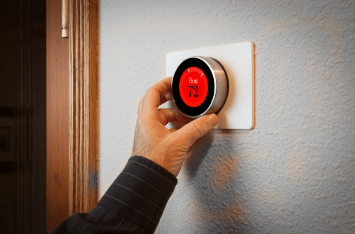 Heating system installation - person setting thermostat to 72 degrees Fahrenheit