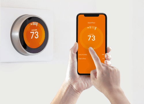 Benefits of a smart thermostat - person controlling a smart thermostat with their phone